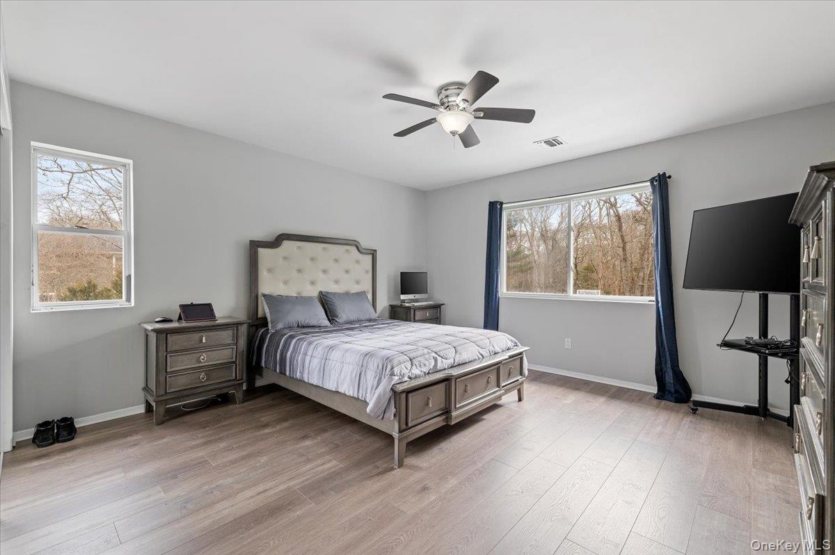 24 Wisteria Drive Remsenburg, NY 11960 - Photo 14 of 44 a bedroom with a bed furniture and a window