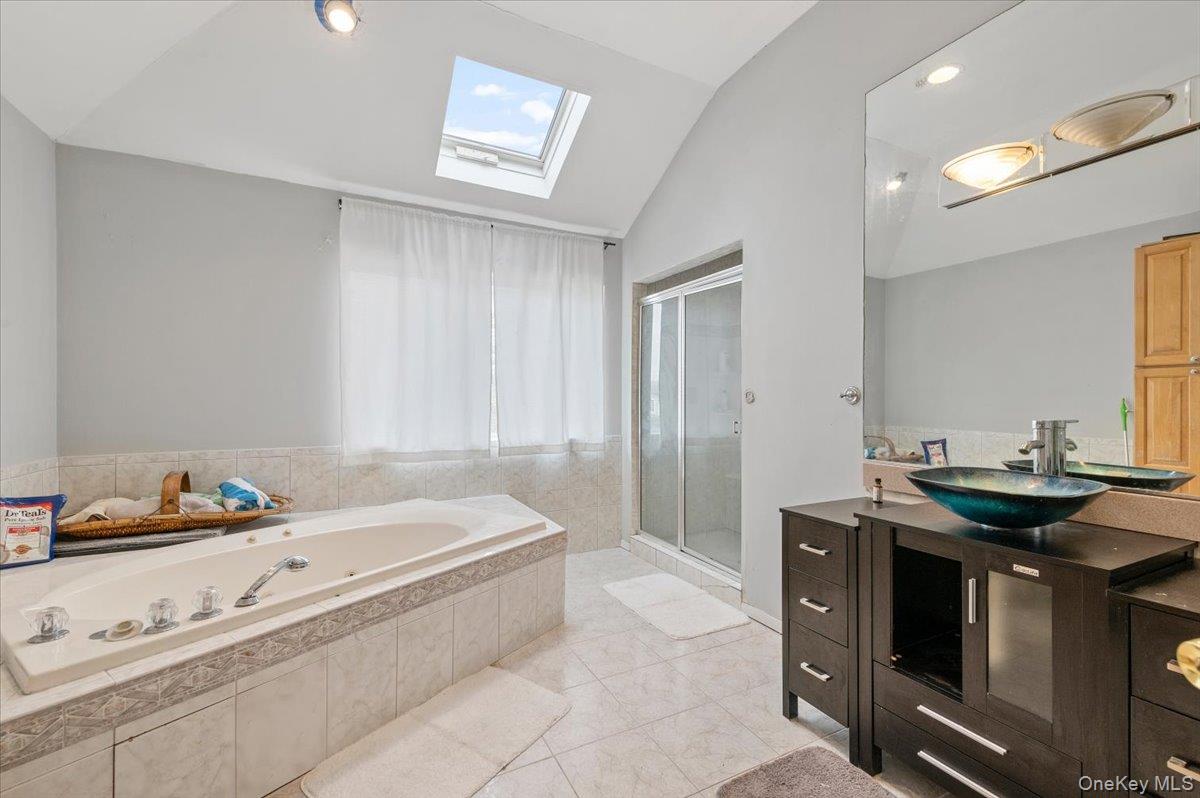 24 Wisteria Drive Remsenburg, NY 11960 - Photo 18 of 44 a bath room with a bath tub and a sink