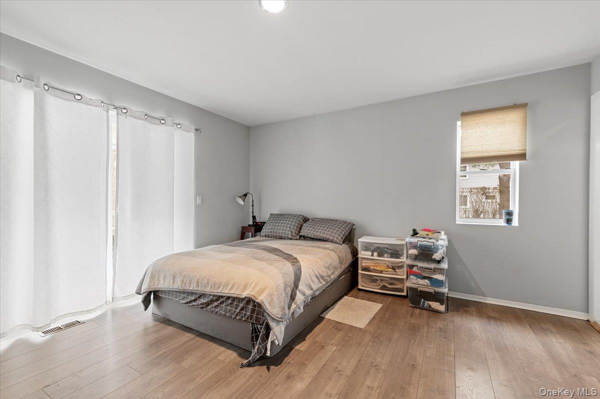 24 Wisteria Drive Remsenburg, NY 11960 - Photo 20 of 44 a bedroom with a bed and a window
