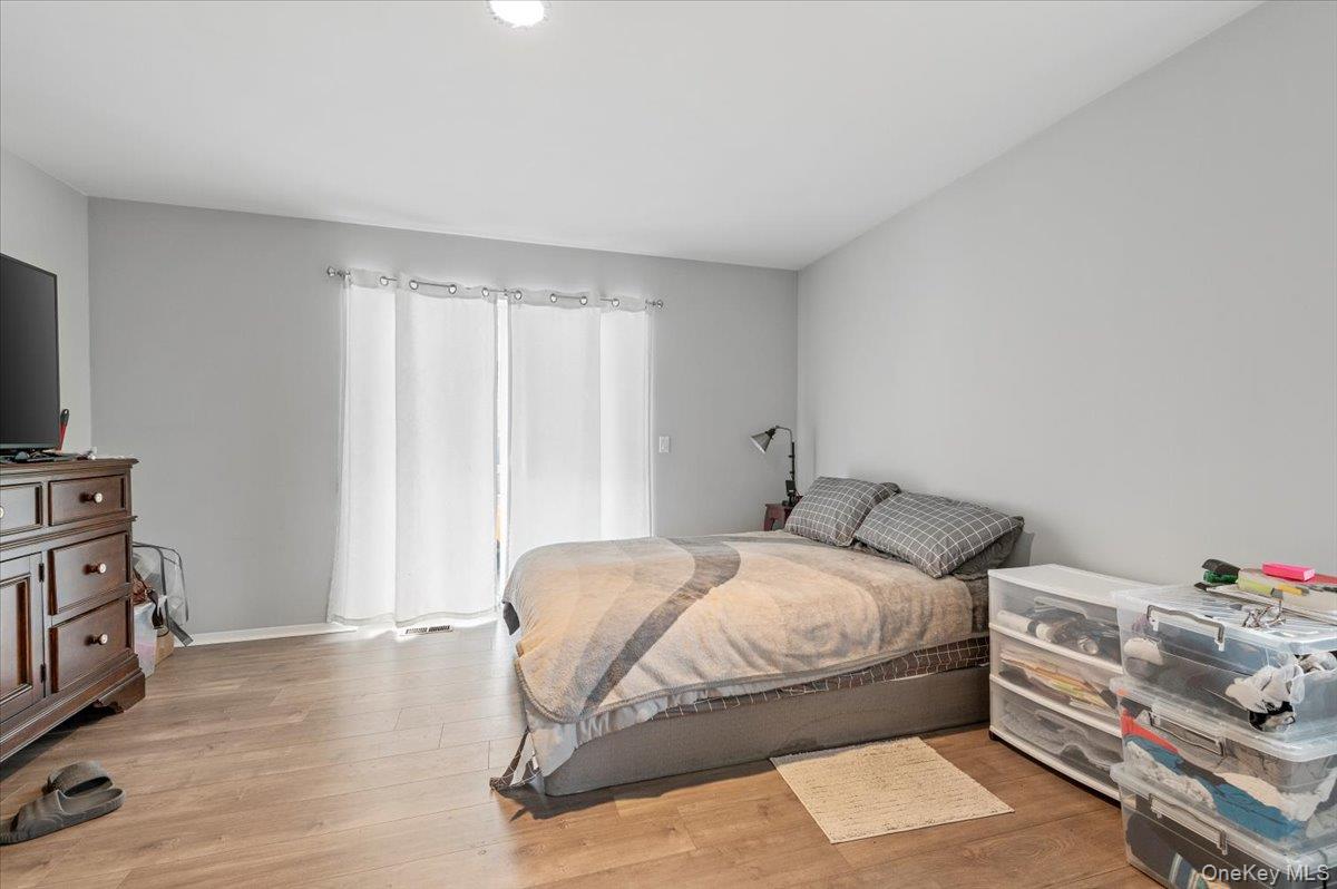 24 Wisteria Drive Remsenburg, NY 11960 - Photo 21 of 44 a bedroom with a bed and a tv