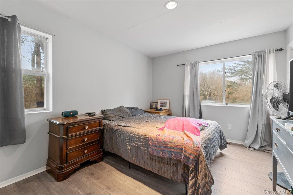24 Wisteria Drive Remsenburg, NY 11960 - Photo 23 of 44 a bedroom with a bed and a window