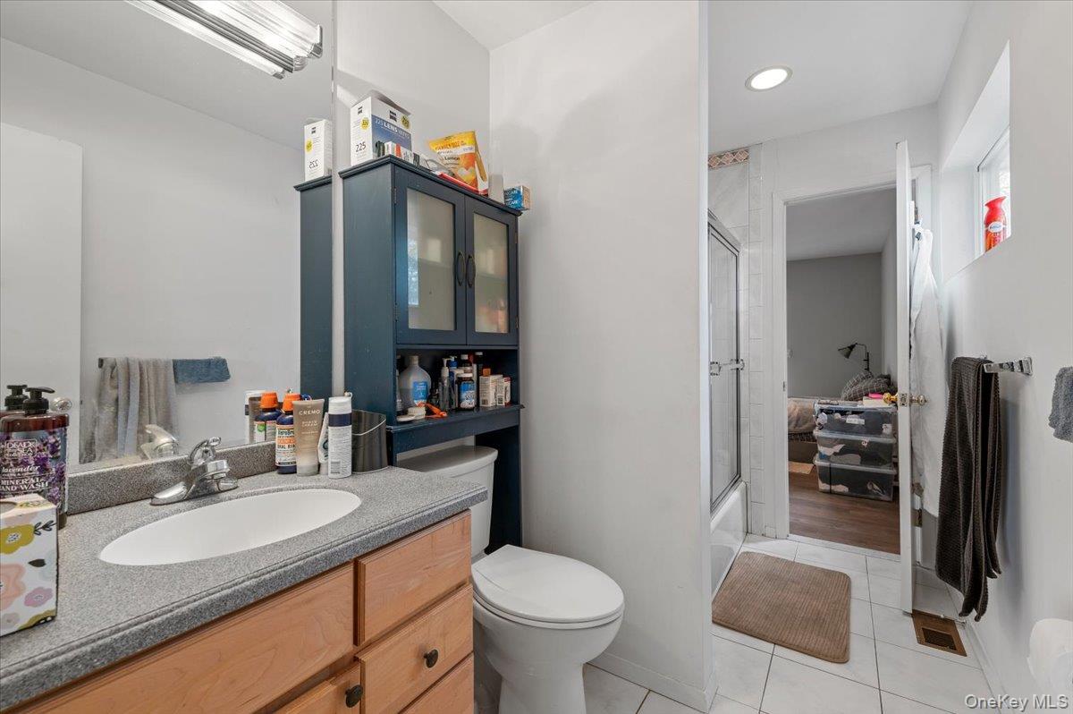 24 Wisteria Drive Remsenburg, NY 11960 - Photo 24 of 44 a bathroom with a sink toilet and a mirror
