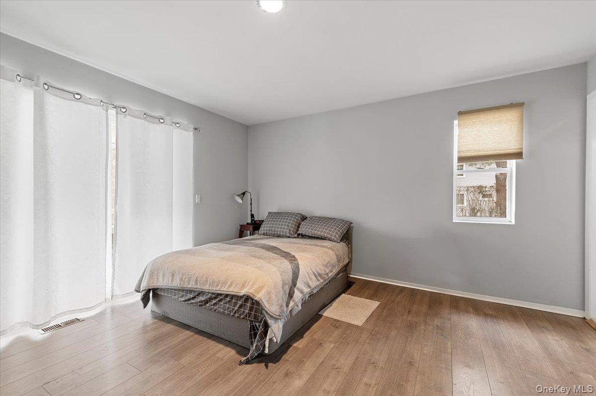 24 Wisteria Drive Remsenburg, NY 11960 - Photo 25 of 44 a bedroom with a bed and a window
