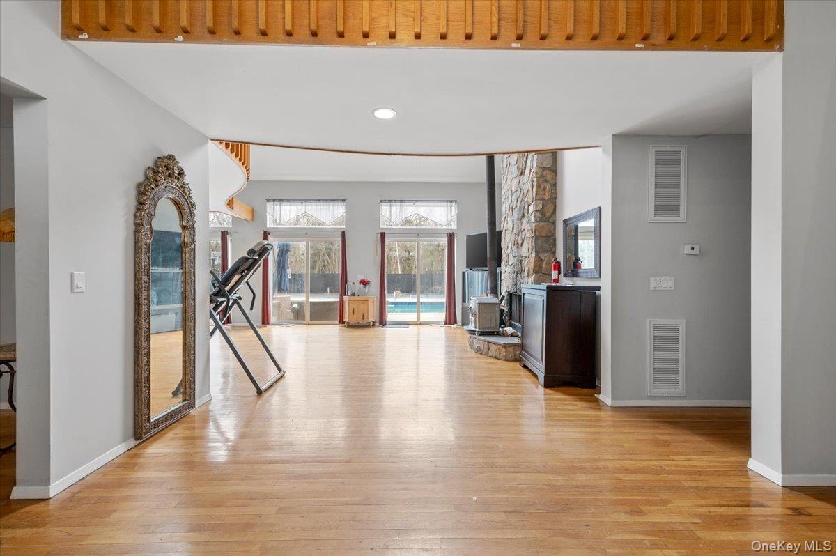 24 Wisteria Drive Remsenburg, NY 11960 - Photo 3 of 44 a view of a hallway with wooden floor