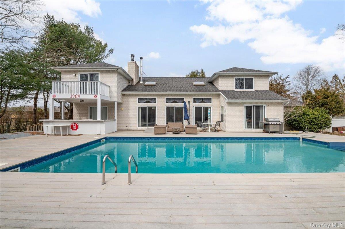 24 Wisteria Drive Remsenburg, NY 11960 - Photo 36 of 44 a house with swimming pool in front of it