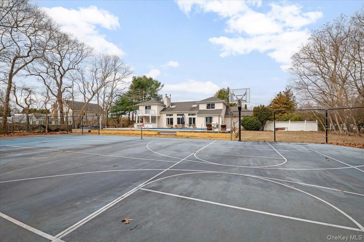 24 Wisteria Drive Remsenburg, NY 11960 - Photo 38 of 44 a view of outdoor space tennis court and trees
