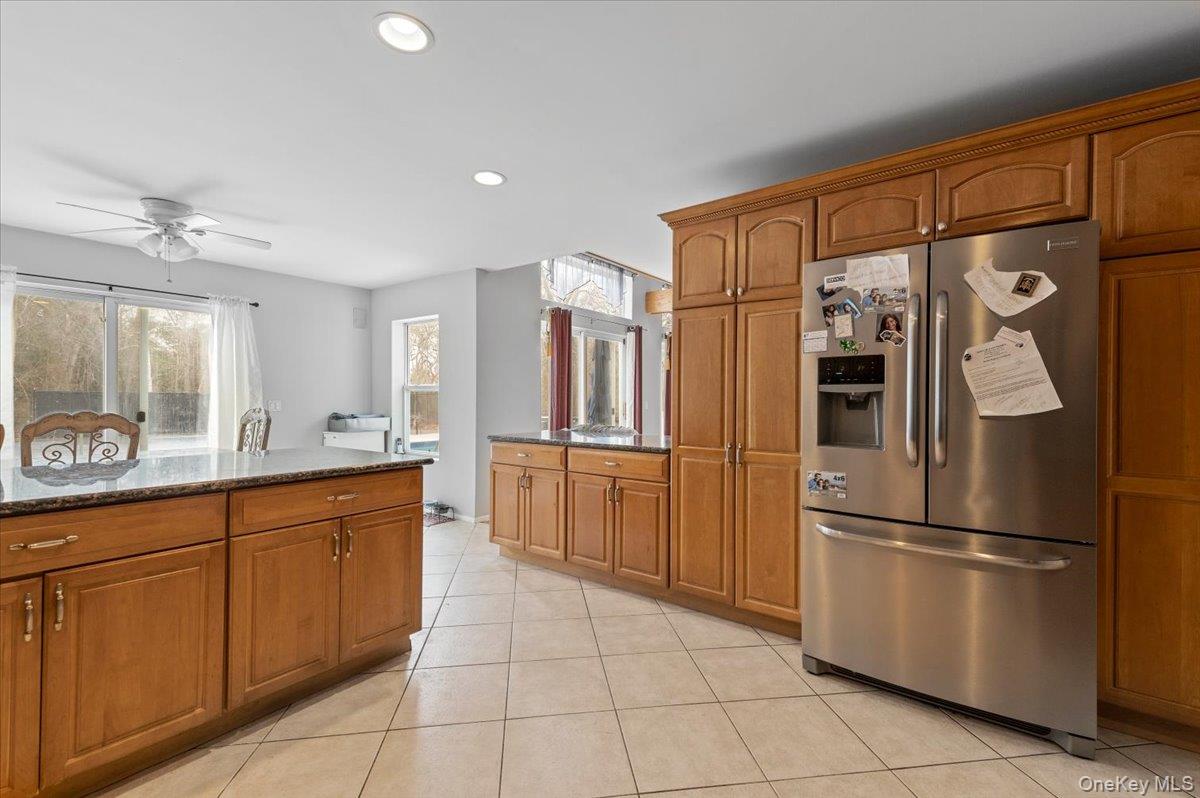24 Wisteria Drive Remsenburg, NY 11960 - Photo 7 of 44 a kitchen with stainless steel appliances a refrigerator and cabinets