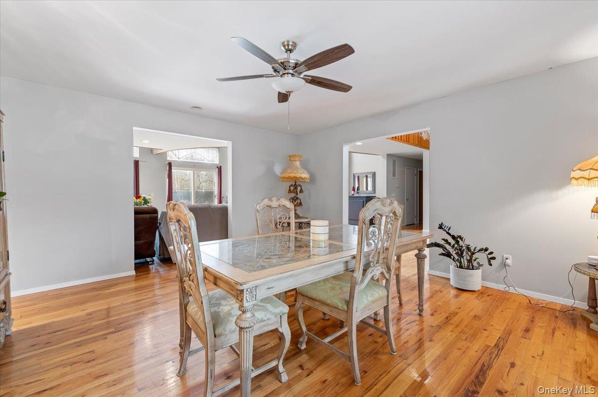24 Wisteria Drive Remsenburg, NY 11960 - Photo 9 of 44 a dining room with furniture and window