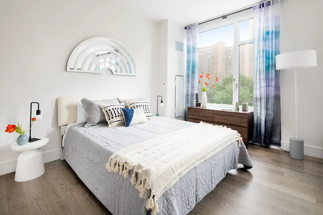 a bedroom with a bed and a window