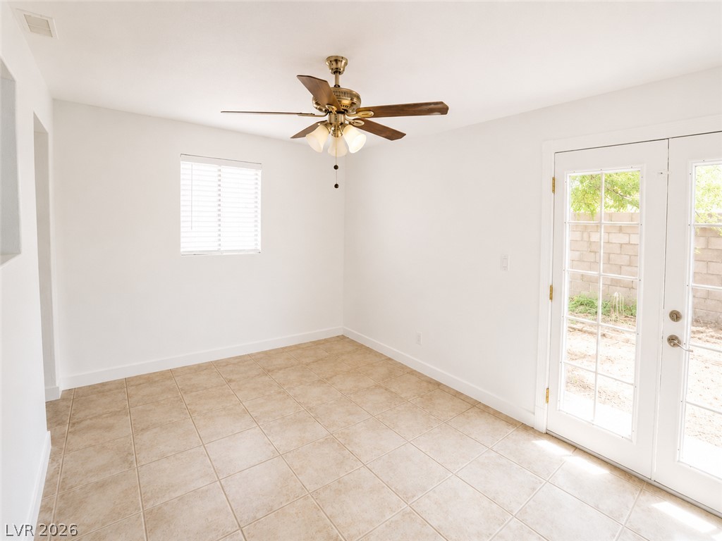 2870 South Sandhill Road Las Vegas, NV 89121 - Photo 20 of 64 A versatile living space with light-colored tile flooring and direct outdoor access.