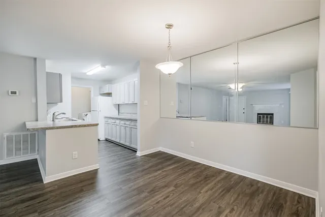 a kitchen with a sink a stove and cabinets