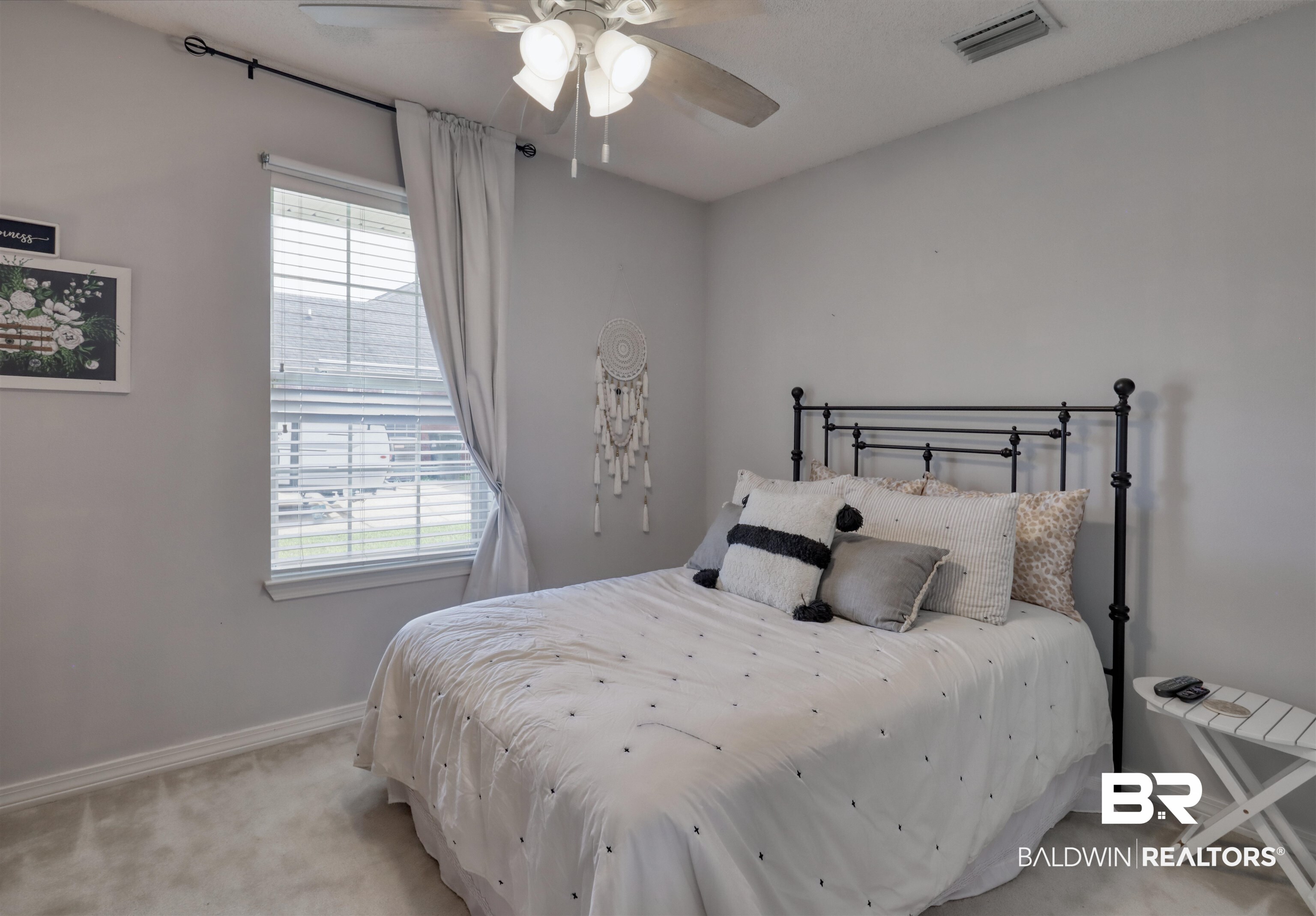 12893 Hunters Chase Foley, AL 36535 - Photo 28 of 42 Bedroom with light carpet, multiple windows, visible vents, and baseboards