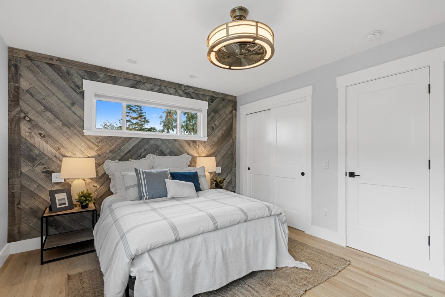 1149 Modoc Street Seaside, CA 93955 - Photo 16 of 37 a bedroom with a large bed and a chandelier