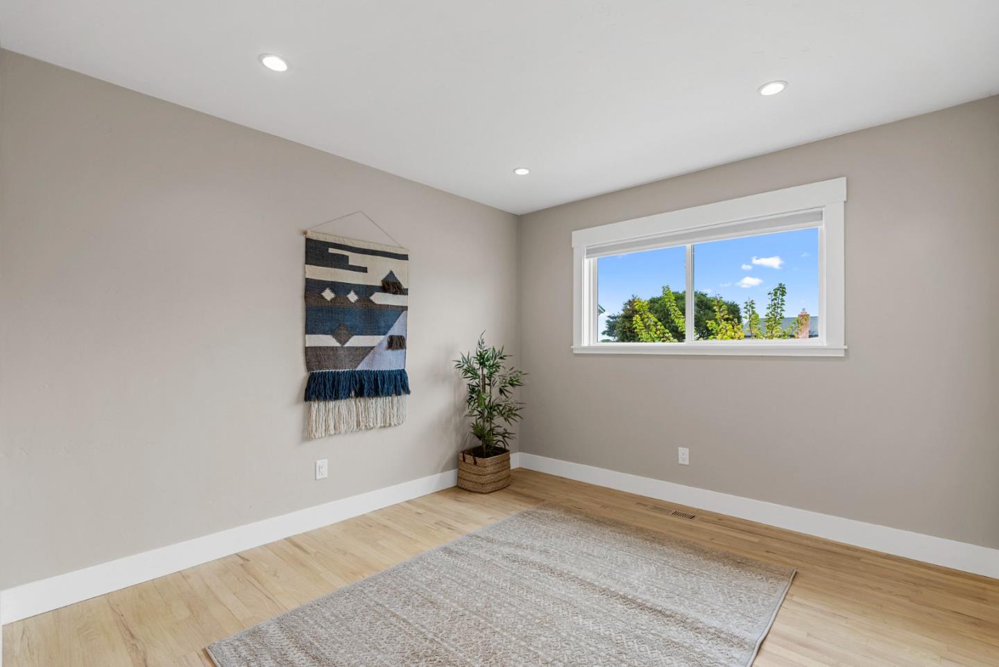 1149 Modoc Street Seaside, CA 93955 - Photo 19 of 37 a room with painting on the wall and a window