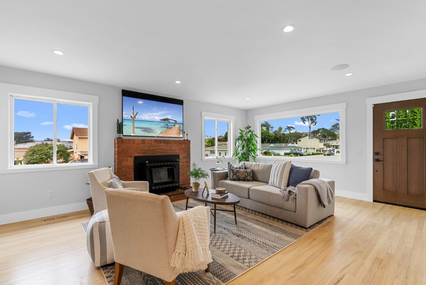 1149 Modoc Street Seaside, CA 93955 - Photo 7 of 37 a living room with furniture a fireplace and a flat screen tv