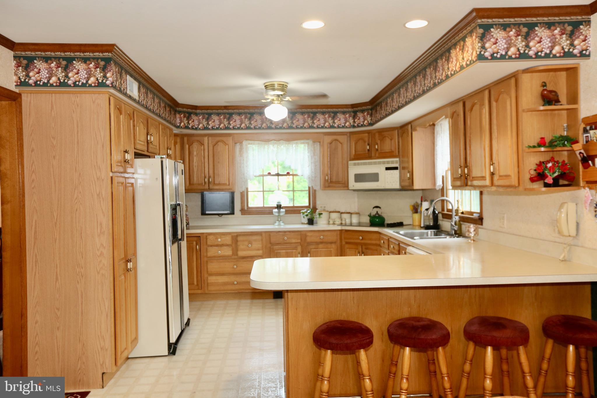 679 Jackson Road Mullica Hill, NJ 08062 - Photo 12 of 41 a kitchen with a refrigerator a sink and cabinets