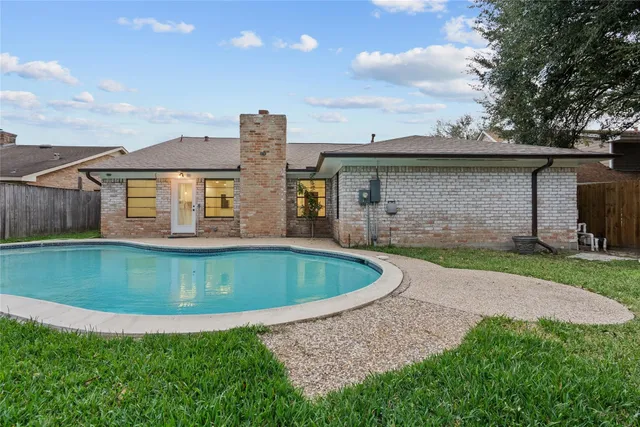 an aerial view of a house with outdoor space swimming pool and lake view