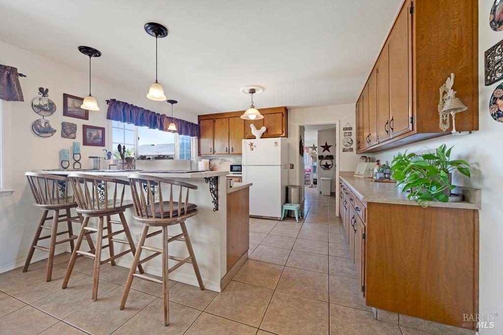 23180 Maffei Road Sonoma, CA 95476 - Photo 19 of 61 Kitchen, counter seating, counter space with a door to laundry/wash room.