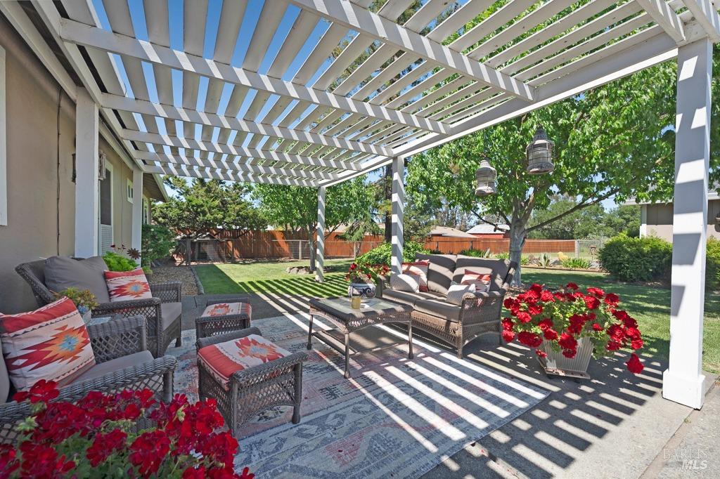 23180 Maffei Road Sonoma, CA 95476 - Photo 32 of 61 Back patio with shaded seating area from over-head pergola and mature trees.