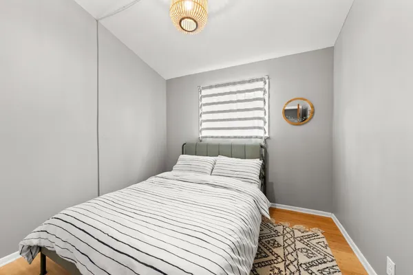 a bedroom with a bed and a mirror