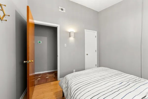 a bedroom with a large bed and a large window