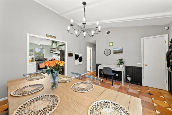 a dining room with furniture and a chandelier
