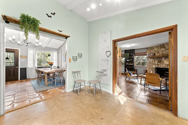a living room with a fireplace furniture and a large window