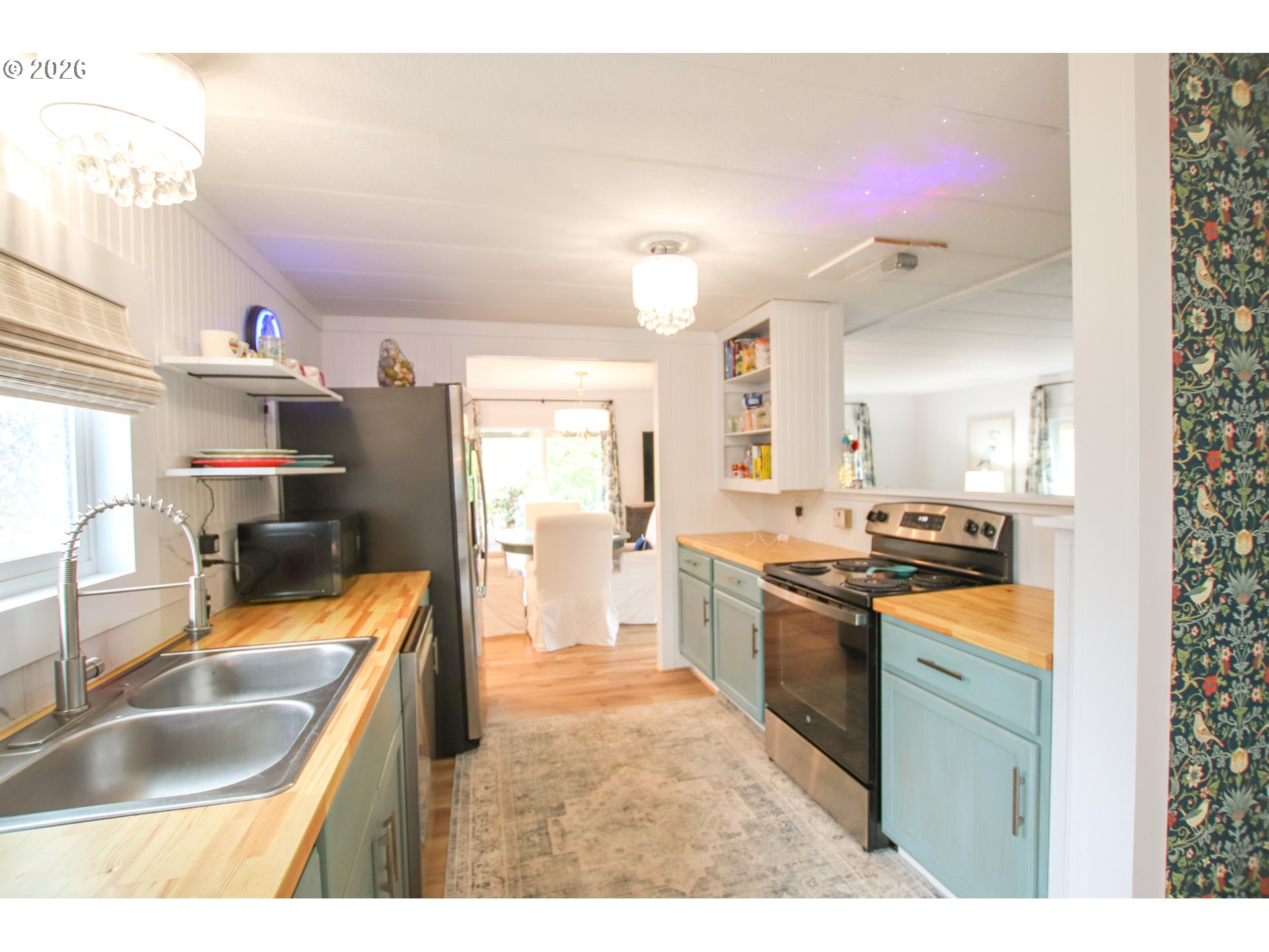 1431 Maple Street Florence, OR 97439 - Photo 13 of 43 a kitchen with stainless steel appliances granite countertop a sink stove and refrigerator