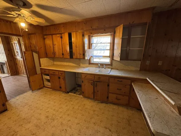 a spacious bathroom with a granite countertop sink and a large mirror