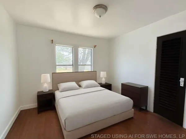 a bedroom with a bed and a night stand