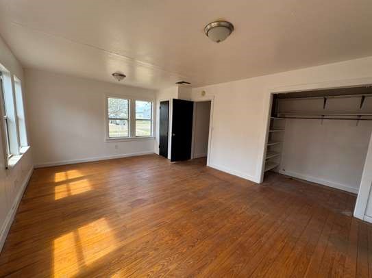910 South 11th Street Slaton, TX 79364 - Photo 8 of 11 an empty room with windows and closet