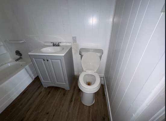 910 South 11th Street Slaton, TX 79364 - Photo 10 of 11 a bathroom with a sink and a toilet