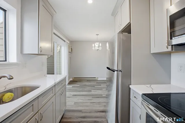 a kitchen with a sink and a refrigerator