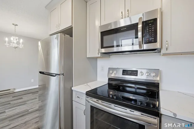 a stove top oven sitting inside of a kitchen