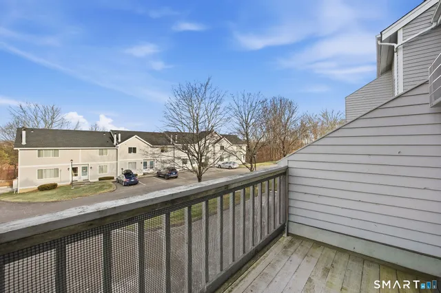 a view of a balcony with wooden fence