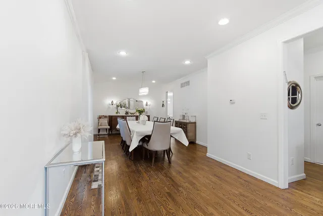 a dining room with furniture and wooden floor