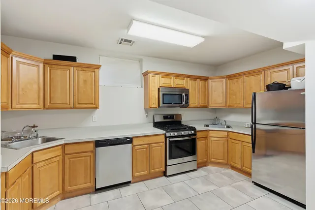 a kitchen with granite countertop stainless steel appliances and cabinets