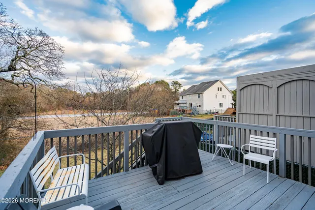 a view of balcony with wooden floor and fence