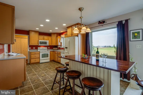 a kitchen with a refrigerator sink and cabinets