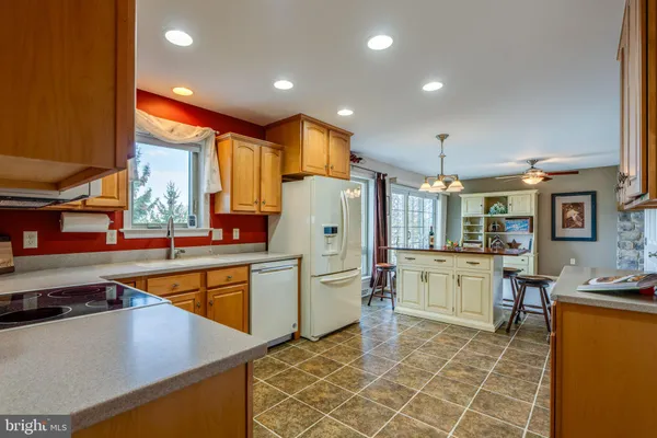 a dining room with furniture a chandelier and wooden floor