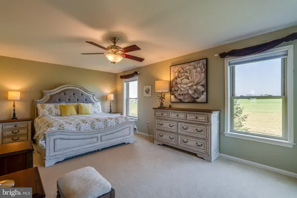 a bedroom with bed and a chandelier