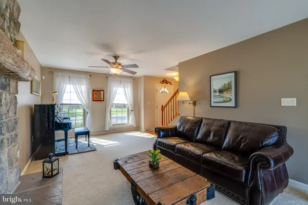 a living room with furniture and kitchen view