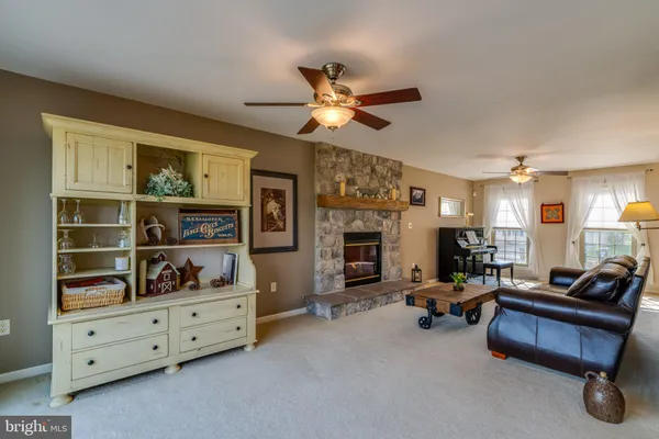 a dining room with furniture a chandelier and window