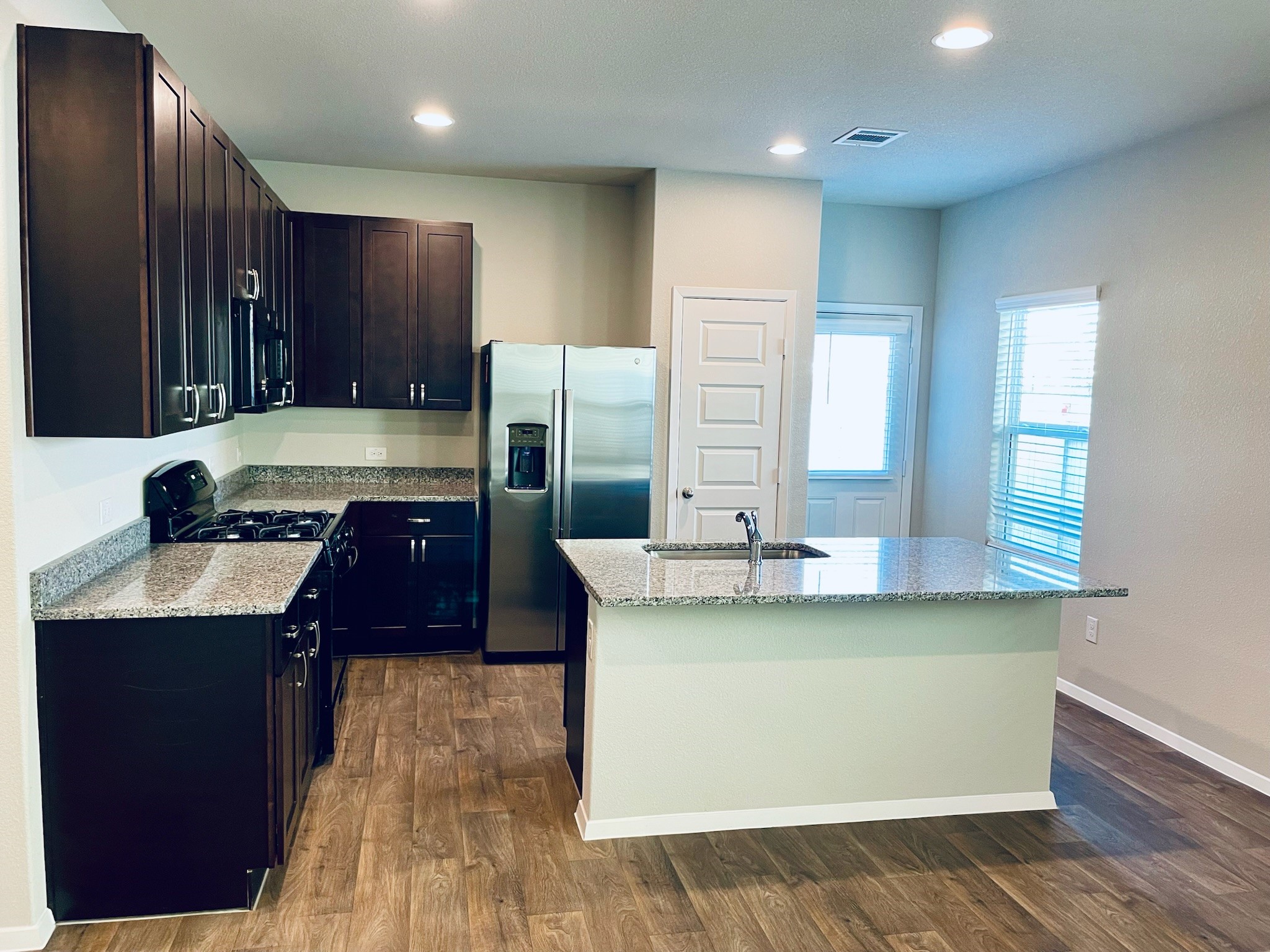 117 Huckleberry Lane Elgin, TX 78621 - Photo 7 of 34 Kitchen with granite countertops, stainless steel appliances and XL island.
