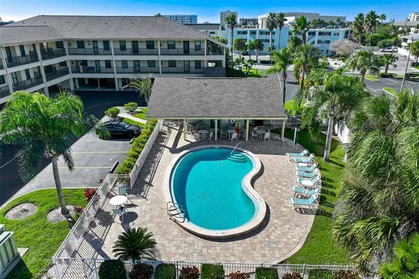 an aerial view of a house with outdoor space and swimming pool