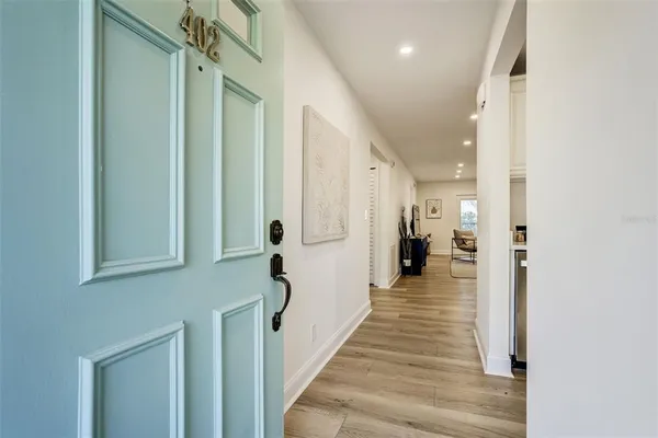 a view of a hallway with wooden floor and staircase