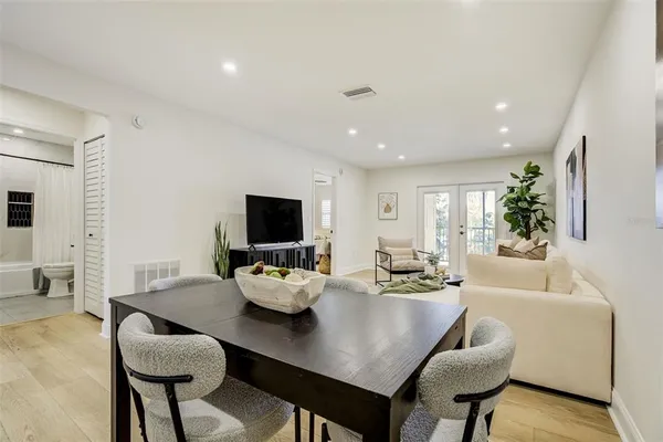 a view of a dining room with furniture and a flat screen tv