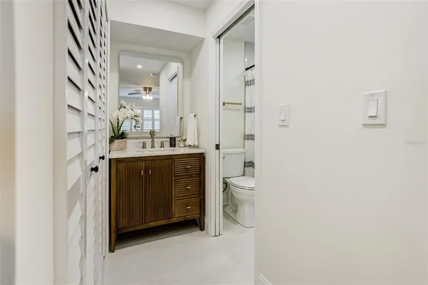 a spacious bathroom with a granite countertop sink a toilet and a mirror
