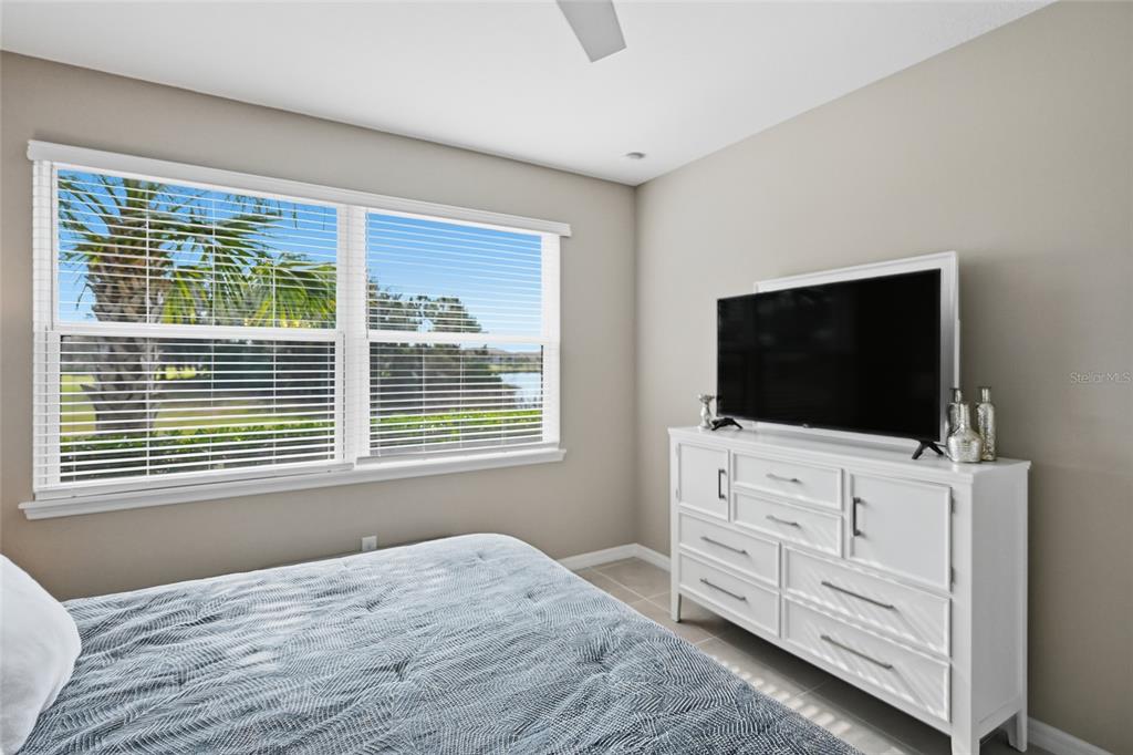 13837 Messina Loop, Unit 101 Bradenton, FL 34211 - Photo 18 of 51 a bedroom with a bed and a flat screen tv