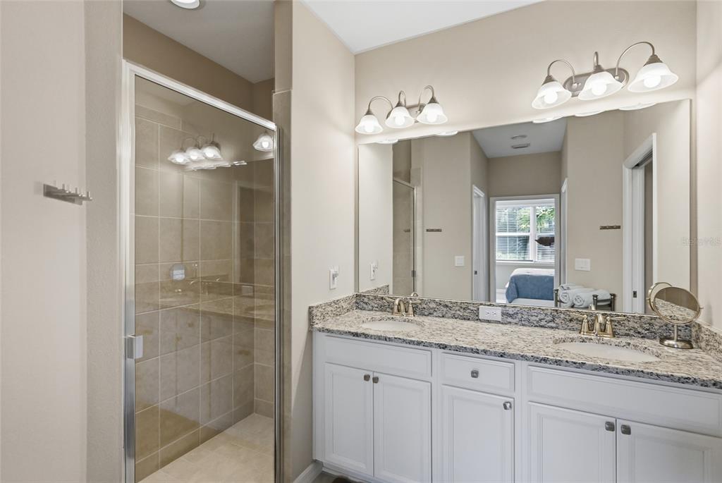 13837 Messina Loop, Unit 101 Bradenton, FL 34211 - Photo 19 of 51 a bathroom with a granite countertop double vanity sink and a mirror